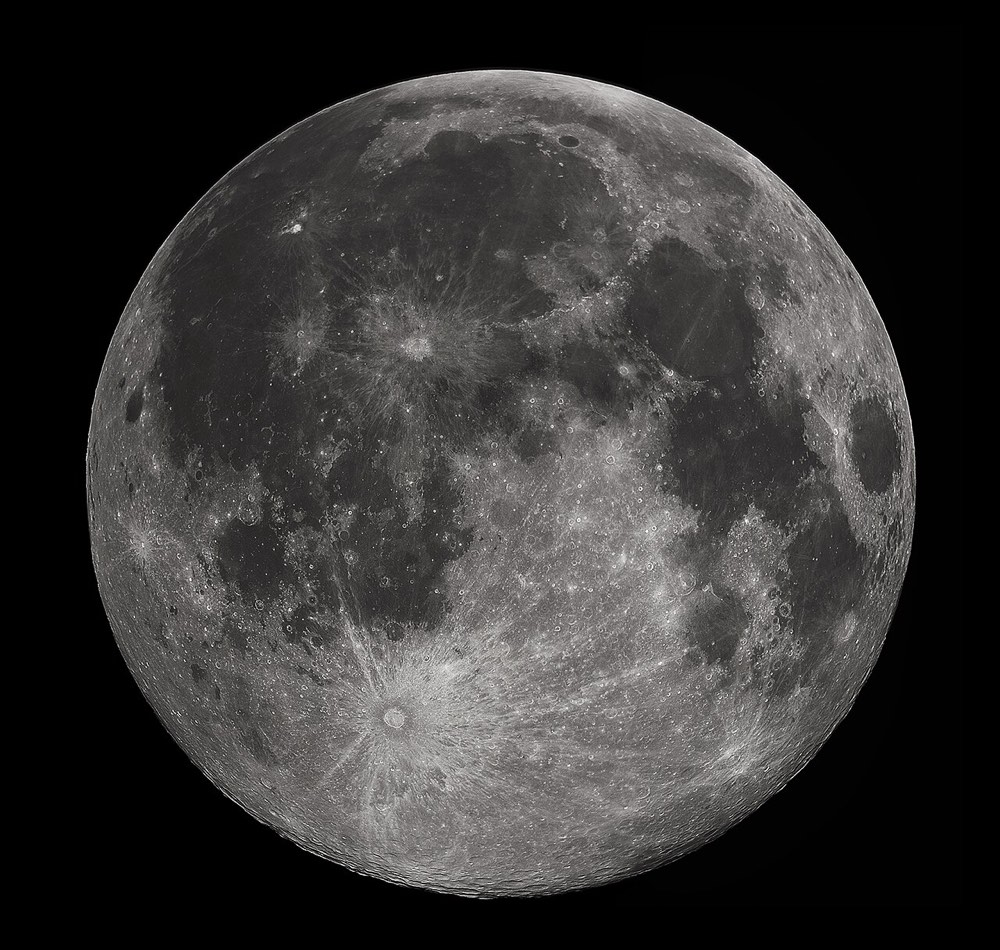 A full Moon with gray maria and bright cratered highlands against a black sky