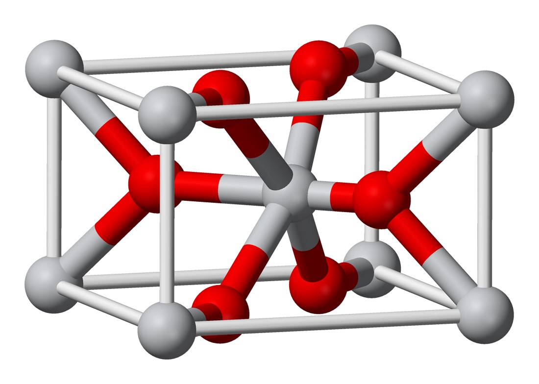 Ball-and-stick model of a rutile unit cell, with grey titanium atoms at the corners and center and red oxygen atoms bonded between them