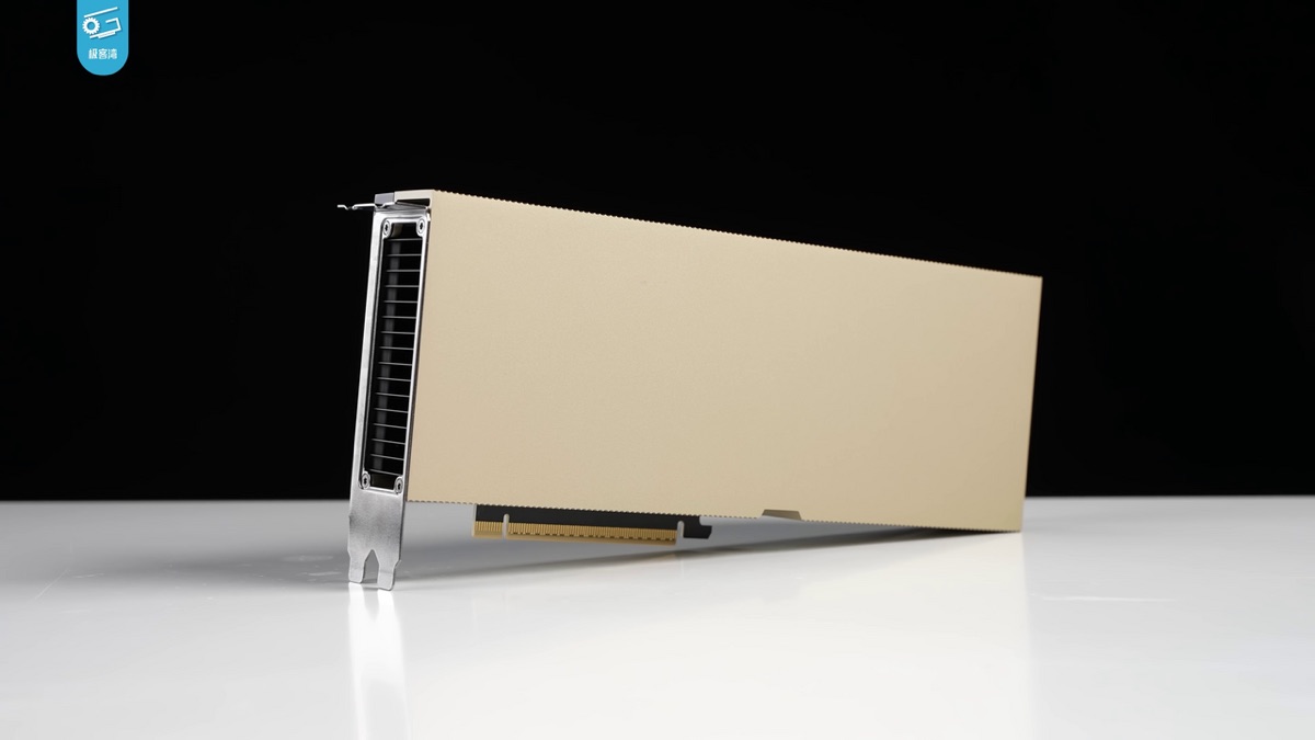A single data-center GPU card standing on a white surface against a black background