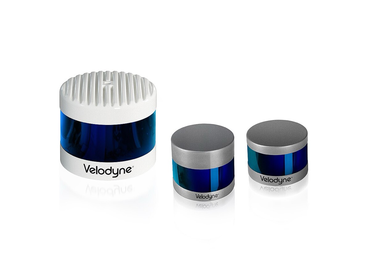 Three cylindrical LiDAR sensors with blue sensor windows, one large white unit and two smaller metal ones, on a white background
