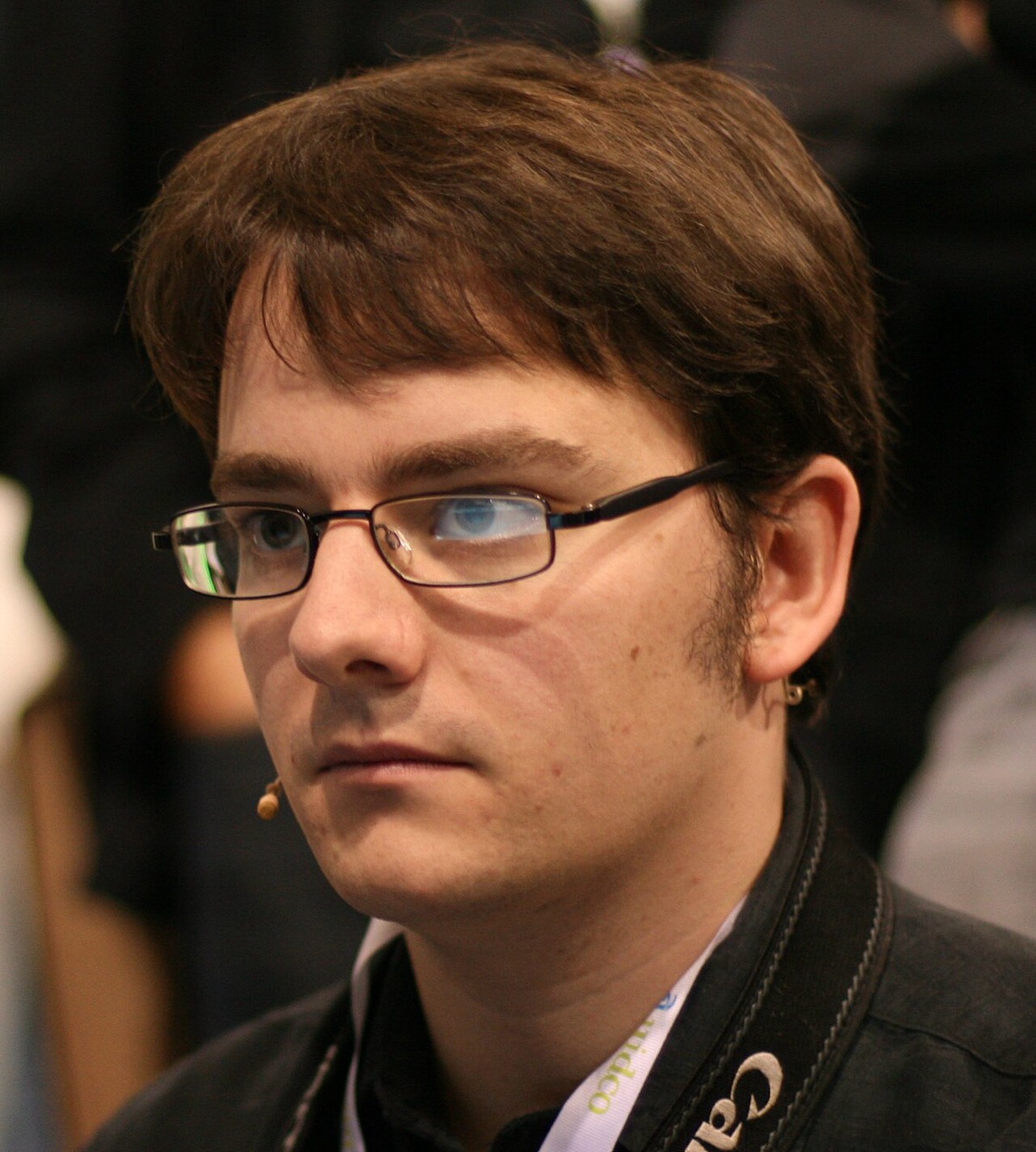 Simon Willison, a man with curly hair and glasses, smiling at a conference in 2008