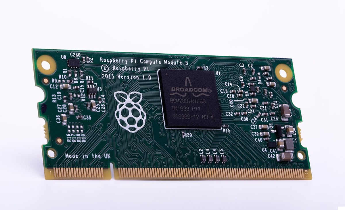 A green Raspberry Pi Compute Module 3 circuit board, shaped like a laptop memory stick